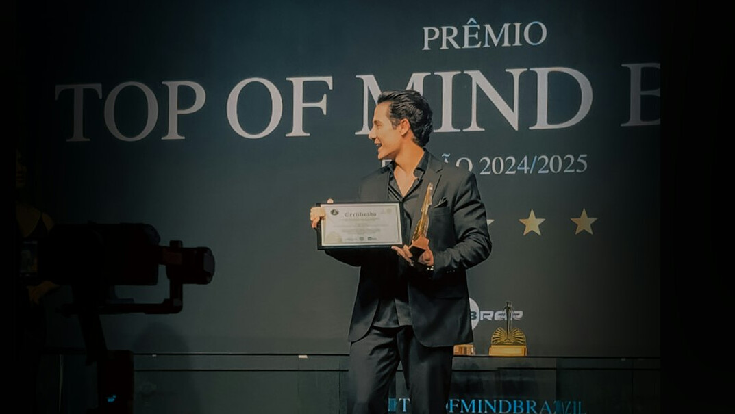 actor holding award on stage