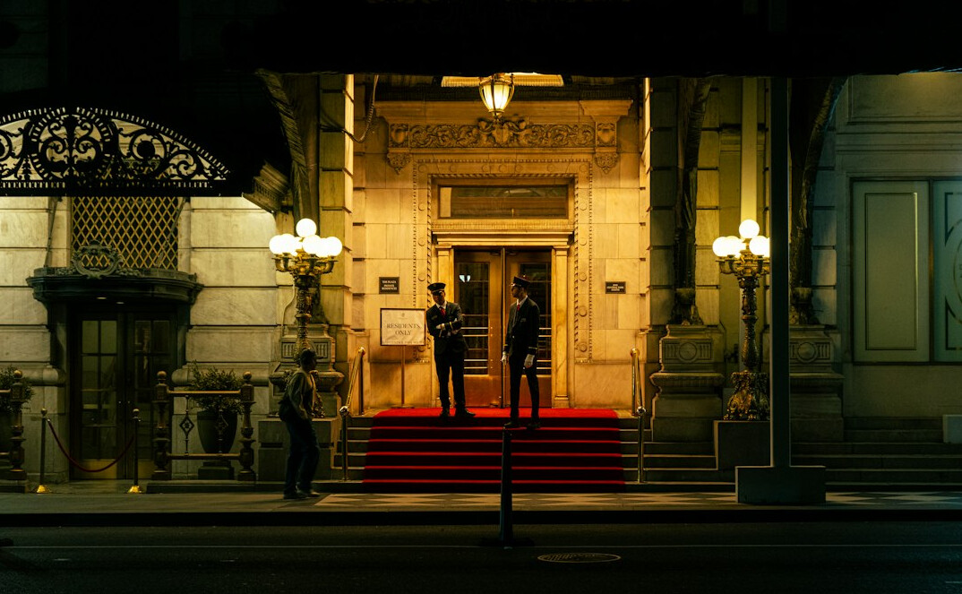 Photographers with cameras and flashes at a red carpet press event
